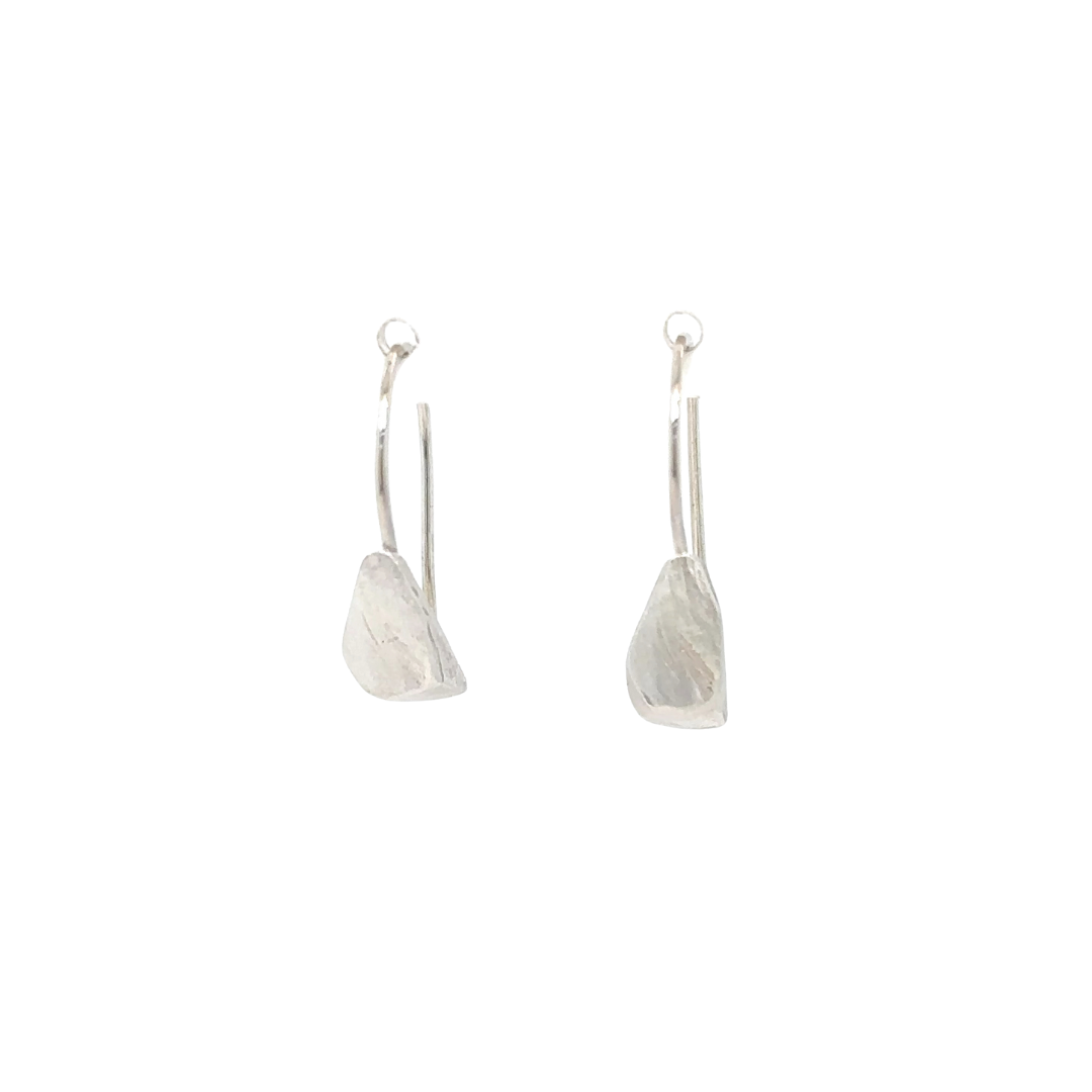 The Echo Earrings are a sculpture distilled in simplicity. A hand-formed piece rests from an ear wire, organic lines recalling the quiet strength found in nature. Lightweight yet impactful, they glow with a subtle radiance that reminds you light doesn't always need to be loud to be seen.