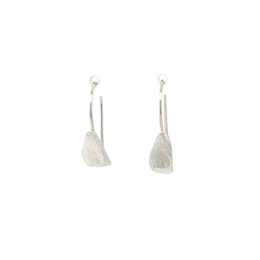 The Echo Earrings are a sculpture distilled in simplicity. A hand-formed piece rests from an ear wire, organic lines recalling the quiet strength found in nature. Lightweight yet impactful, they glow with a subtle radiance that reminds you light doesn't always need to be loud to be seen.