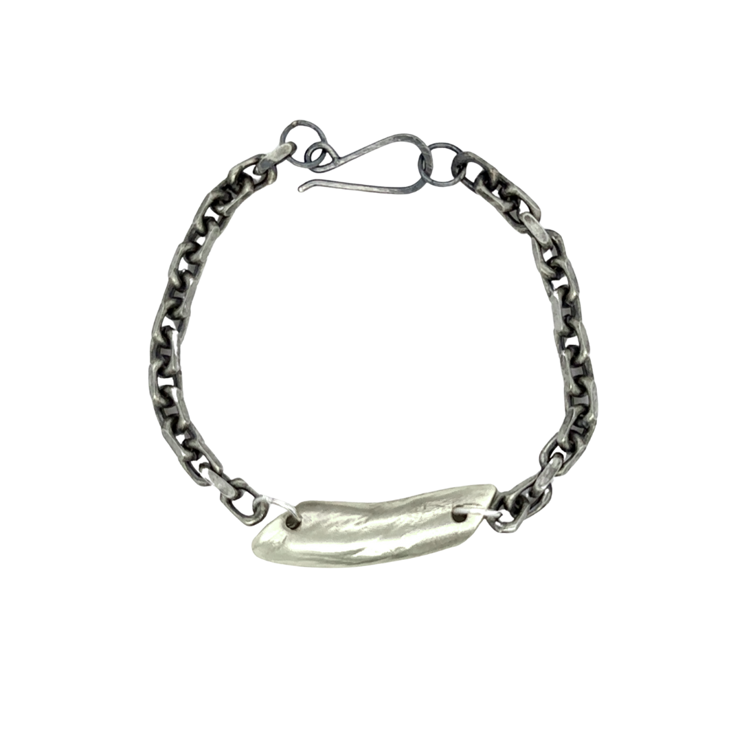 The Pulse Chain Bracelet anchors strength and grace at your wrist. A bold oxidized chain is centered with a hand-sculpted form that is raw, organic, and full of quiet power.