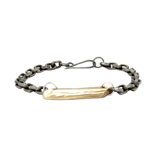 The Pulse Chain Bracelet anchors strength and grace at your wrist. A bold oxidized chain is centered with a hand-sculpted form that is raw, organic, and full of quiet power.