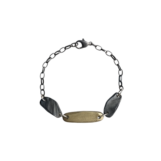 Delicate yet durable, this bracelet features intricately woven strands that symbolize the interconnectedness of life's experiences. The adjustable clasp ensures a perfect fit for any wrist size This exquisite piece combines the brilliance of bronze, and the cool sophistication of oxidized sterling silver in a harmonious design.