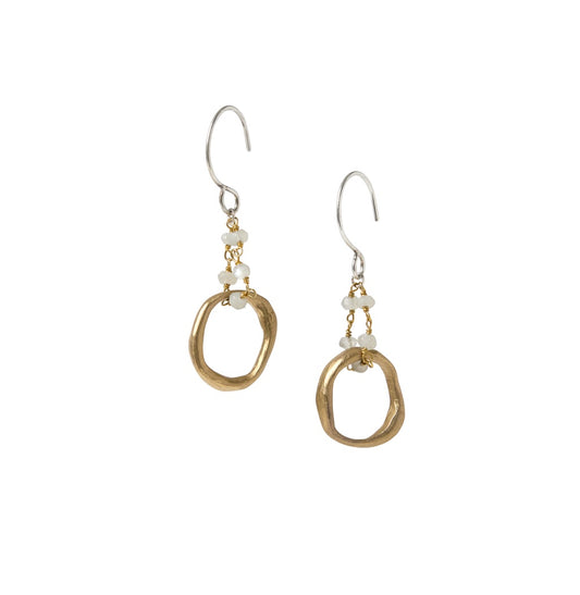 The Lunar Cascade Earrings in bronze or silver have hoops suspended from delicate moonstone chains. As light catches the translucent moonstones, they reveal hidden depths - just like the layers of yourself waiting to be discovered.