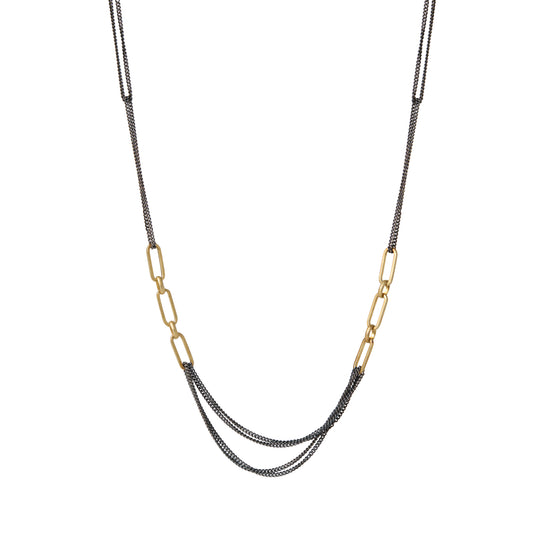 This striking dual-chain necklace embodies the meeting point between opposing forces – oxidized sterling silver chains flowing like cosmic dust alongside bold 14k plate golden links that capture rays of celestial light. The asymmetrical design mirrors the beautiful unpredictability of personal evolution.