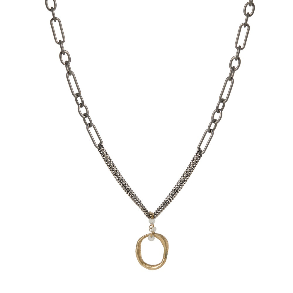 The Eclipse Embrace Necklace captures the precise moment of celestial alignment, when the sun and moon create something entirely new. The pendant's contrasting metals intertwine on a substantial chain, reminding you that your own evolution contains multitudes – strength and vulnerability, certainty and possibility, endings and beginnings.