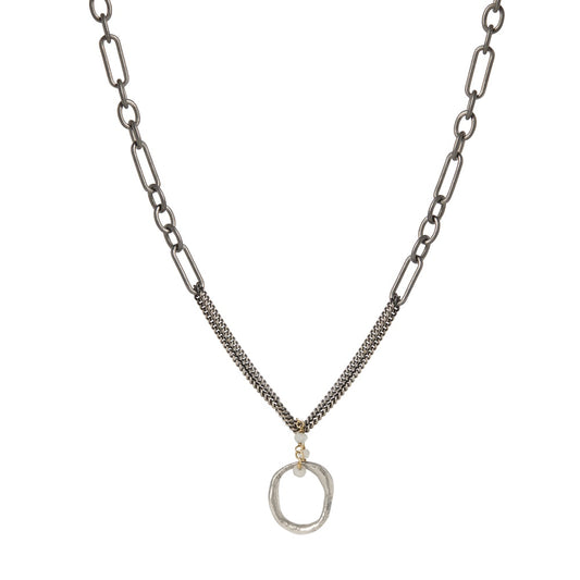 The Eclipse Embrace Necklace captures the precise moment of celestial alignment, when the sun and moon create something entirely new. The pendant's contrasting metals intertwine on a substantial chain, reminding you that your own evolution contains multitudes – strength and vulnerability, certainty and possibility, endings and beginnings.