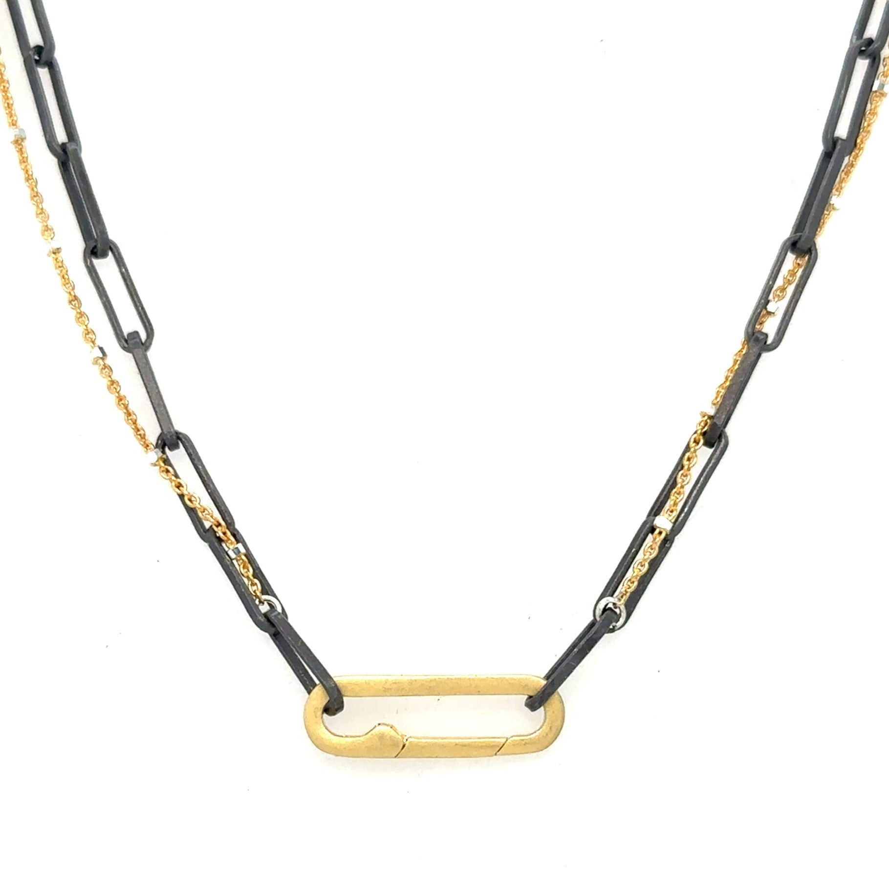 A blend of two worlds in one exquisite piece. This necklace features two chains: one in sophisticated black oxidized sterling silver and the other in luxurious 14K gold-filled metal. The contrasting tones create a subtle yet striking visual interest, perfect for those who appreciate nuanced style.
