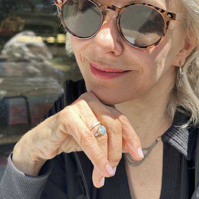 Tempest Hoop Earrings, Kintsugi 18kt Gold Ring, and Cascade Layers Necklace on a person