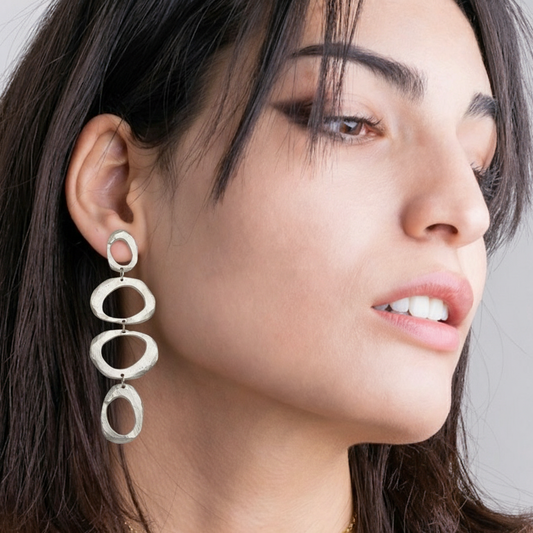 A bold fusion of ancient symbolism and contemporary design. The Mystic Statement Earrings feature intricate patterns inspired by mystical traditions, meticulously crafted in rich, warm bronze or sparkling silver. Each earring is a miniature work of art, with textures and details that catch the light and draw the eye. The substantial yet balanced design ensures a comfortable wear, while making a dramatic statement.