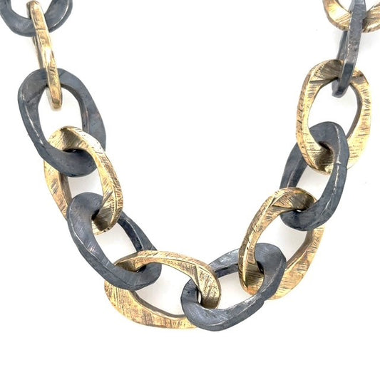The Illumina Link Necklace is a bold mixed-metal necklace in bronze and oxidized silver. Hand-sculpted links celebrate strength, connection, and wabi-sabi beauty.