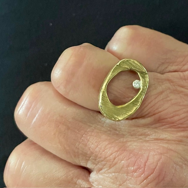 Close up of Ovum Ring in Bronze on persons hand