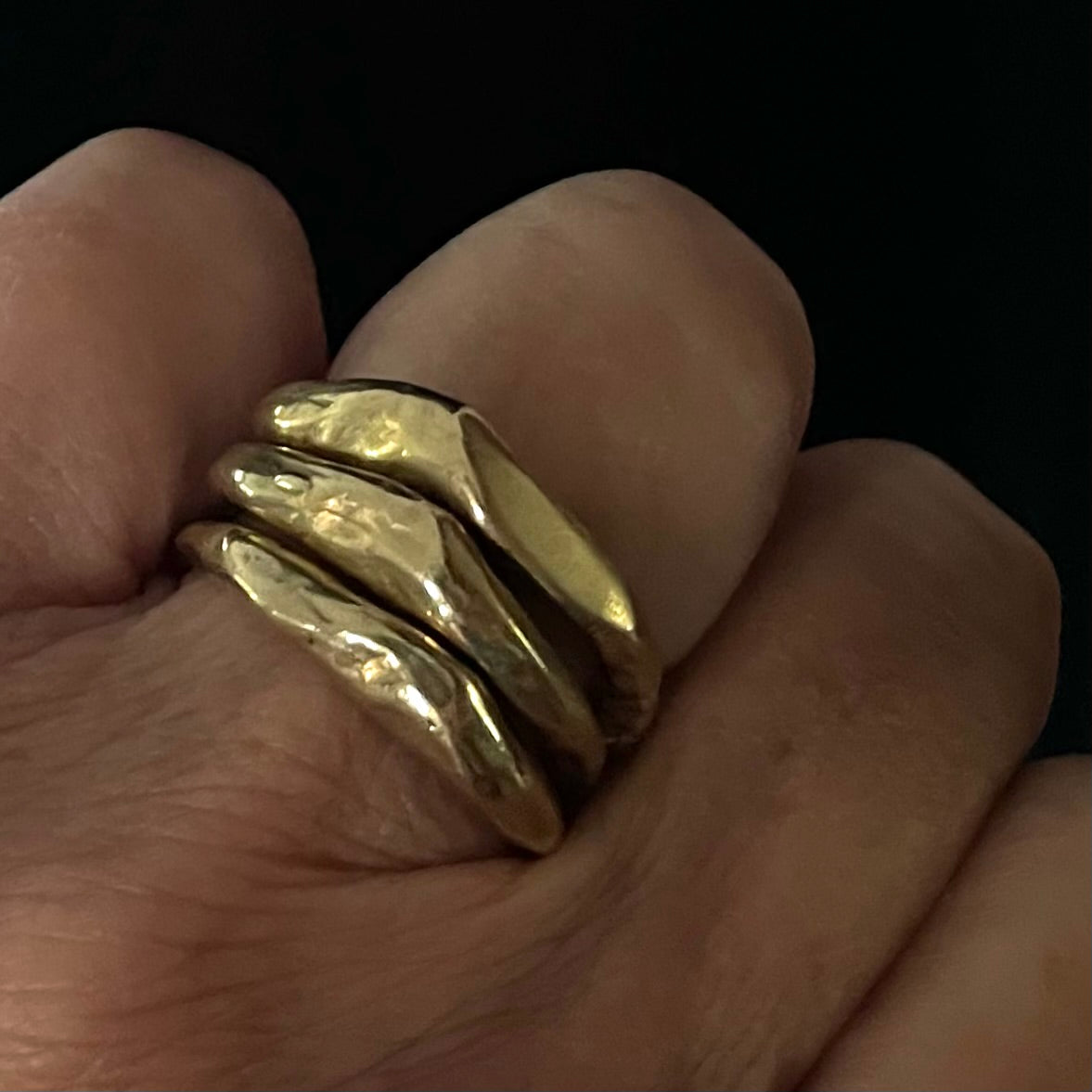 Alchemist Stacking Rings in Bronze on a persons hand