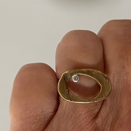 The Ovum Ring is a timeless and symbolic piece perfect for anyone looking to manifest a new chapter in their life. Ovals have been used to represent rebirth since ancient times, and this ring is no exception.  Its sleek design features a perfectly shaped oval with a bezel set white diamond. It's a powerful symbol and a reminder that no matter what happens in life, there is always a chance for renewal and growth.