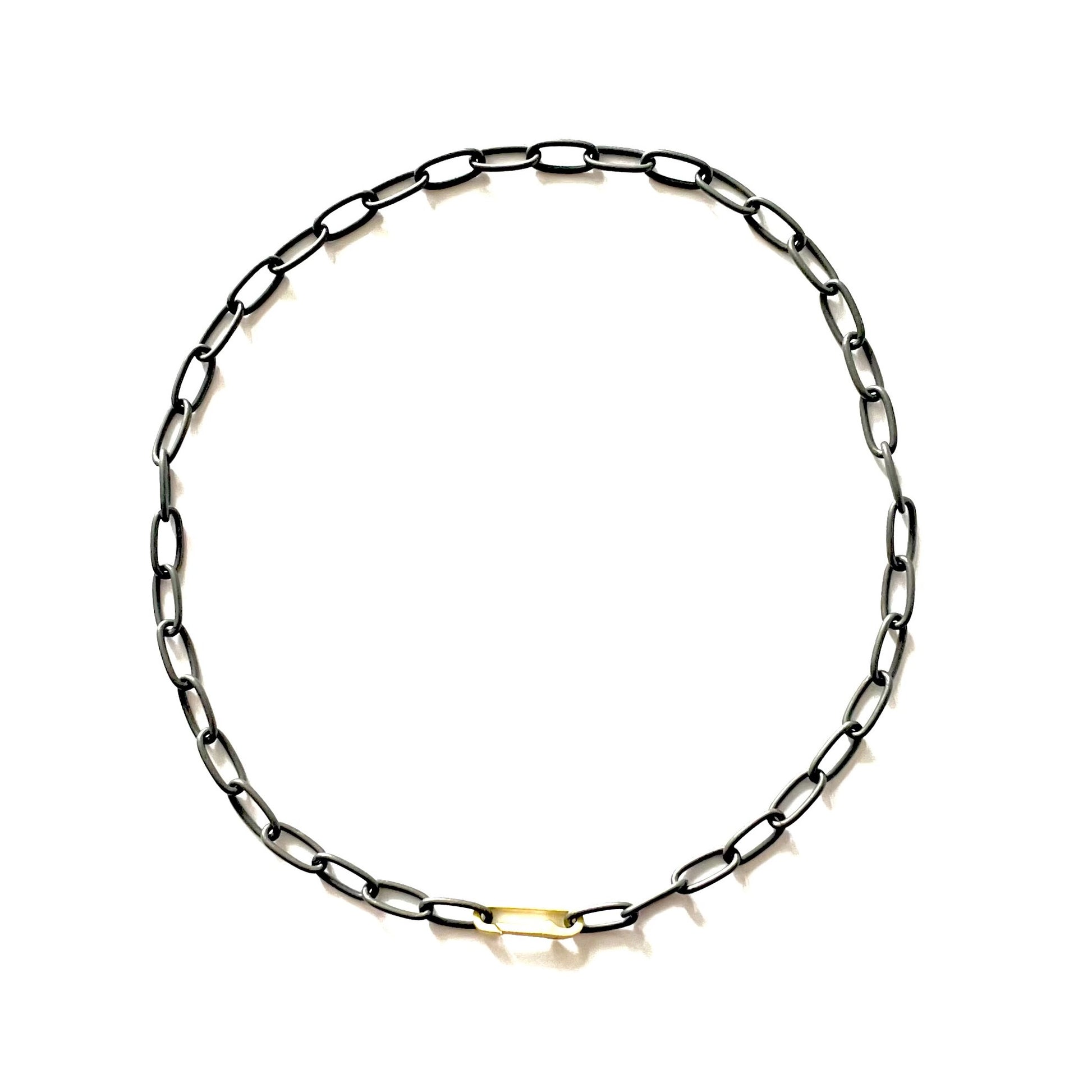 When you wear the Large Link Black Silver Chain with Paper Clip Connector, you're immediately infused with a sense of cool confidence. There's a subtle rebellious thrill in wearing something so unconventional yet effortlessly chic.