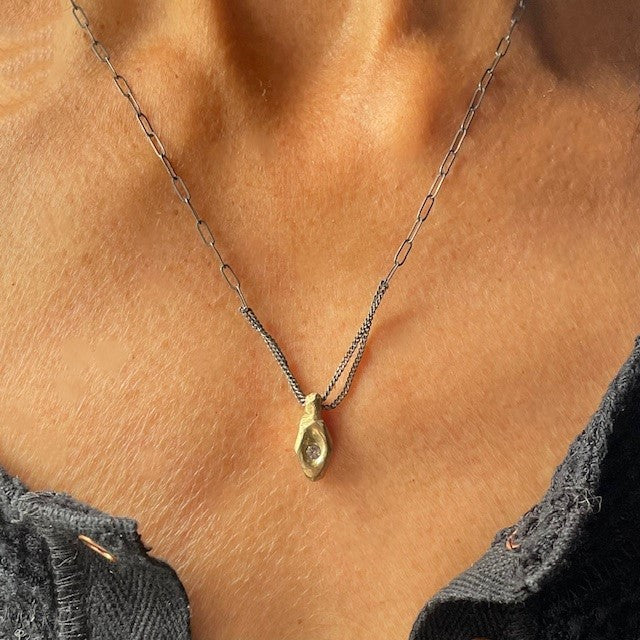 In ancient Japan, warriors and travelers carried mamori - sacred talismans believed to ward off harm and channel protective energies. Our Mamori Talisman carries this centuries old intention into a modern heirloom, bridging worlds through deliberate design and precious materials.