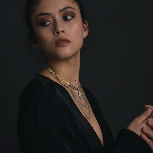 Modern Gold Link Chain with Double Paper Clip Clasp and Desire Talisman layered with the Mixed Metal Layered Necklace on model.
