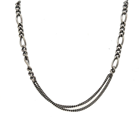 The Not So Basic Chain embodies the perfect contradiction - refined yet primitive, sophisticated yet organic. This exclusive piece features two distinct oxidized silver chains to create a base layer that invites exploration and personal expression.