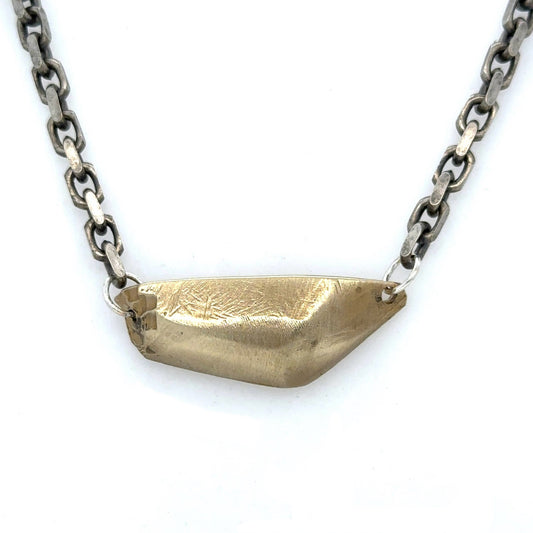 The Vestige Necklace carries the strength of what remains. A bold, sculptural form rests at the center, solid and commanding, yet at its edges, fragments break away. It's a reminder that awakening is not about what we lose, but what endures.
Suspended on a bold oxidized chain, the 18" Vestige Necklace sits close to the heart, grounding you in presence and sovereignty. The weight is intentional, the form unapologetic.