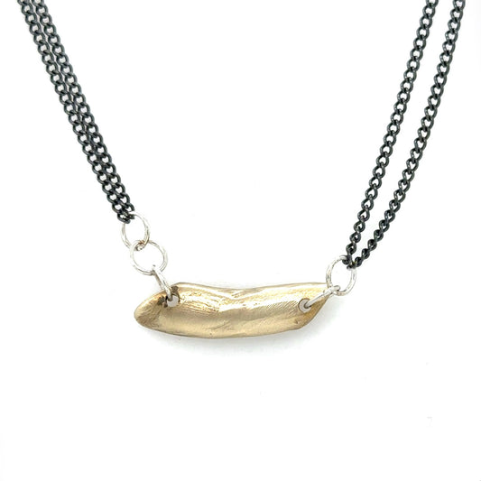 The Whisper Necklace rests softly at the nape of your neck, like a secret promise you carry close. A sculptural form anchors dual oxidized silver chains and it's raw edges are a reminder of the beauty that emerges from imperfection.