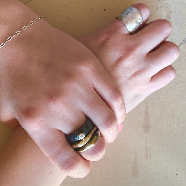 The Origin Ring in silver and other Chikahisa Rings shown on hands