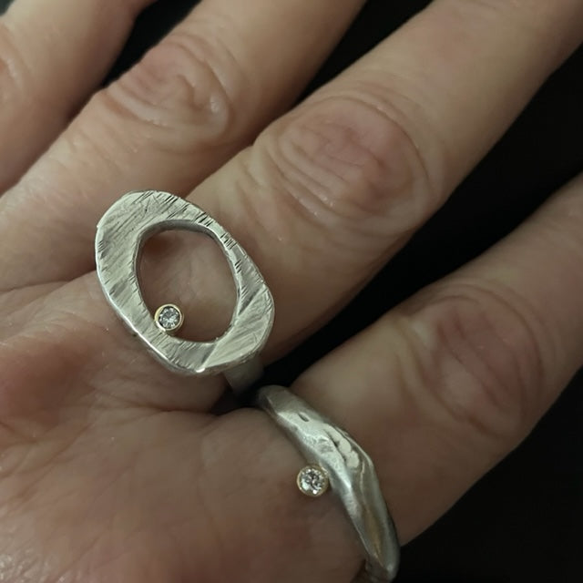 The Ovum Ring is a timeless and symbolic piece perfect for anyone looking to manifest a new chapter in their life. Ovals have been used to represent rebirth since ancient times, and this ring is no exception. Its sleek design features a perfectly shaped oval with a bezel set white diamond. It's a powerful symbol and a reminder that no matter what happens in life, there is always a chance for renewal and growth.