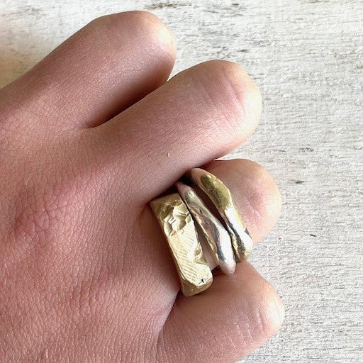 Solar Terrain Ring in Bronze shown stacked with Element Rings on persons hand