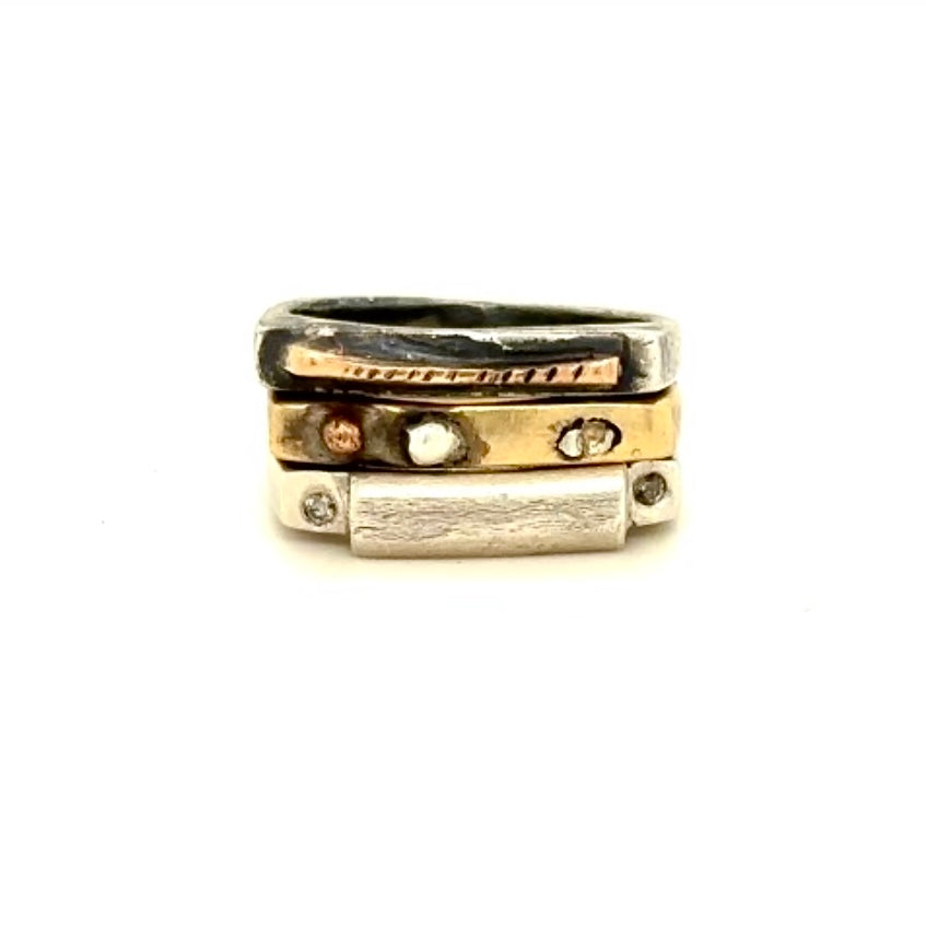 The Trinity Ring Stack is a mix of metals and precious stones and when you stack them together, they create a synergy that reflects the beautiful interplay of body, mind, and spirit.