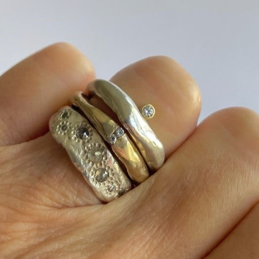 Thrive; Channel in Bronze; Odyssey in Silver Chikahisa Studio Rings shown on persons hand