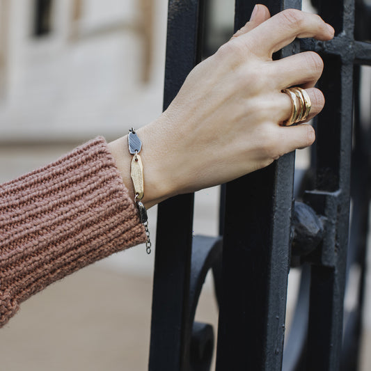 Model wearing stack of three Element Rings in Bronze
