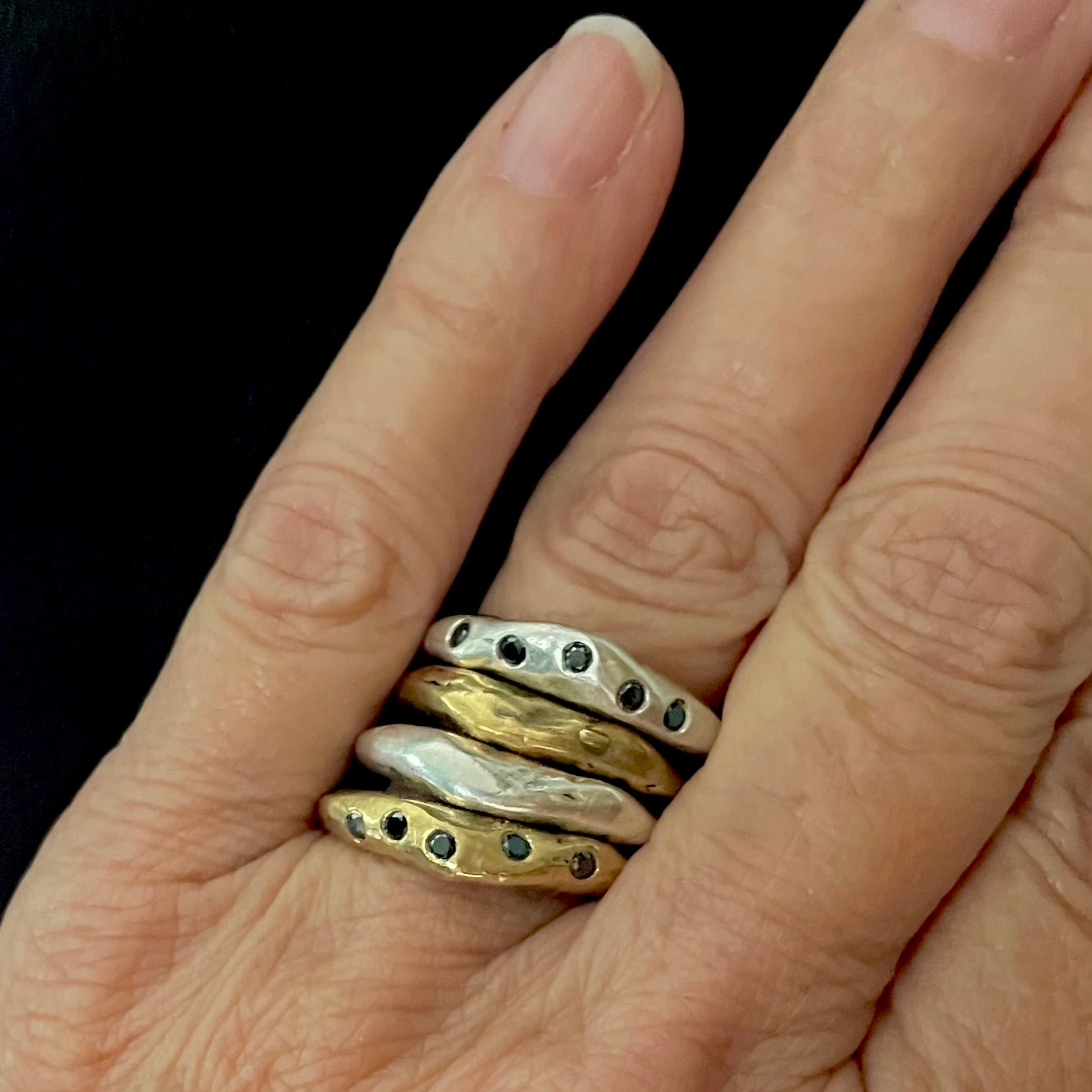 Shown on hand are Silver and Bronze Constellation Rings stacked with Silver and Bronze Element Rings