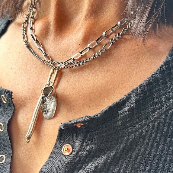 Necklace with a pendant worn by a person, close-up view.