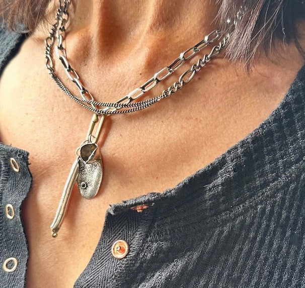 Necklace with a pendant worn by a person, close-up view.