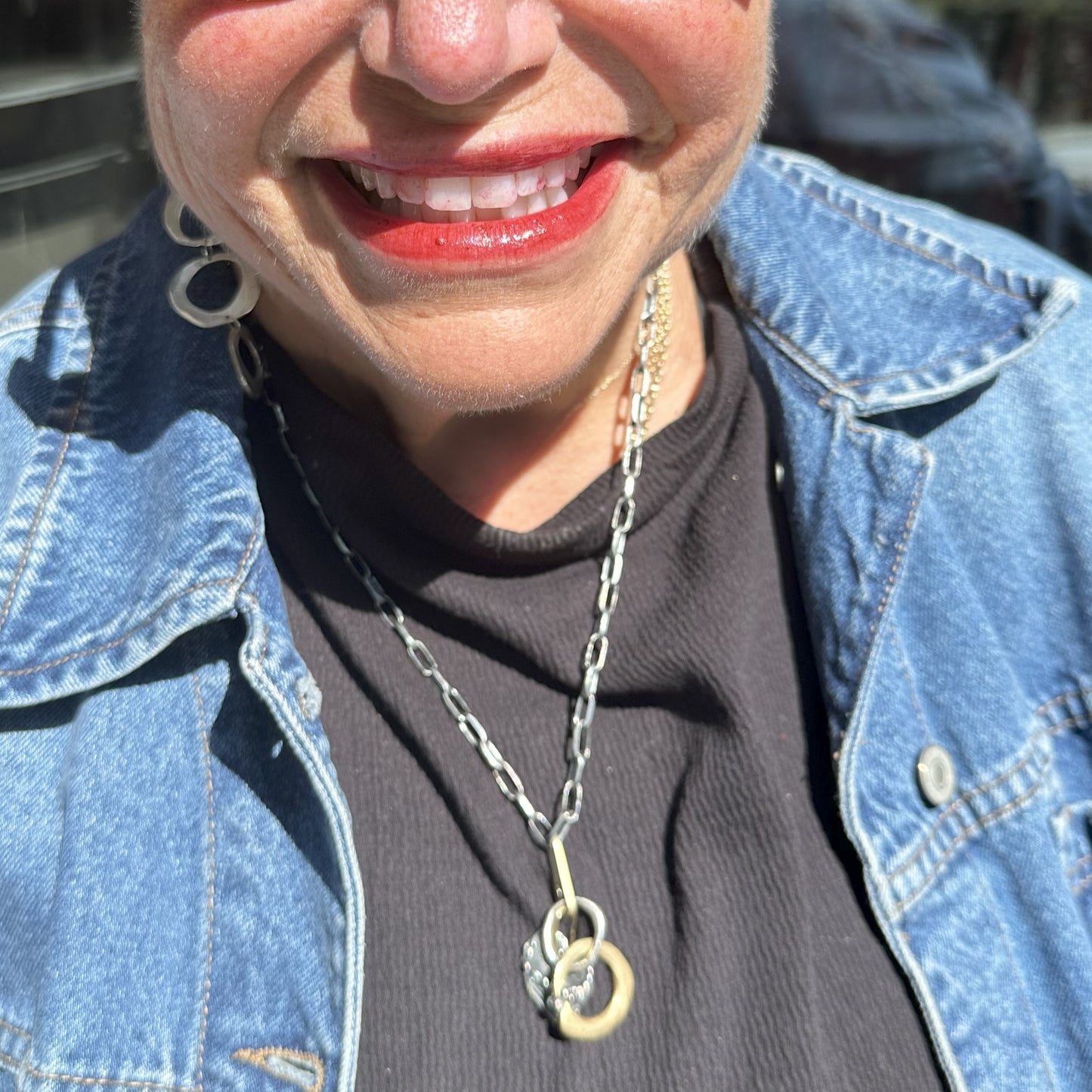 Person wearing a necklace featuring the Ascendant and Lo e Talisman Pendants