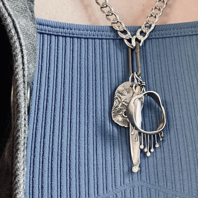 Healing, Strength, and Hope Talisman Pendants shown on Flat Curb Cain