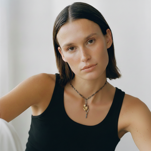 Model wearing Compassion + Love Talisman Pendants on Oxidized Silver Chain