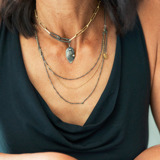 Close up of the Modern Gold Link Chain with Double Paper Clip Clasp and Desire Talisman layered with the Mixed Metal Layered Necklace