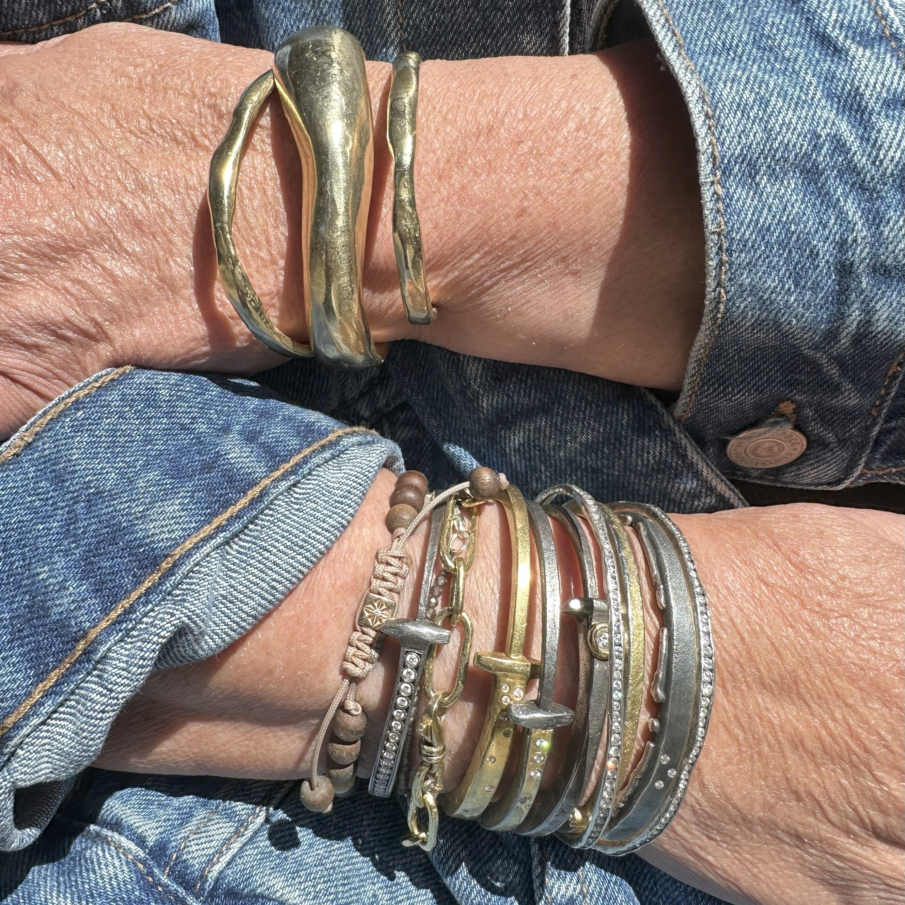 Customer stack of own bracelets with the Tidal Force Cuff on right arm. Left arm features 2 Divine Thin Cuffs and 1 Divine Wide Cuff.