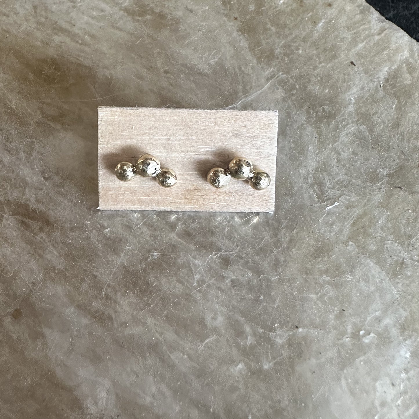 Hoshi Stud Earrings shown on wood fiber paper
