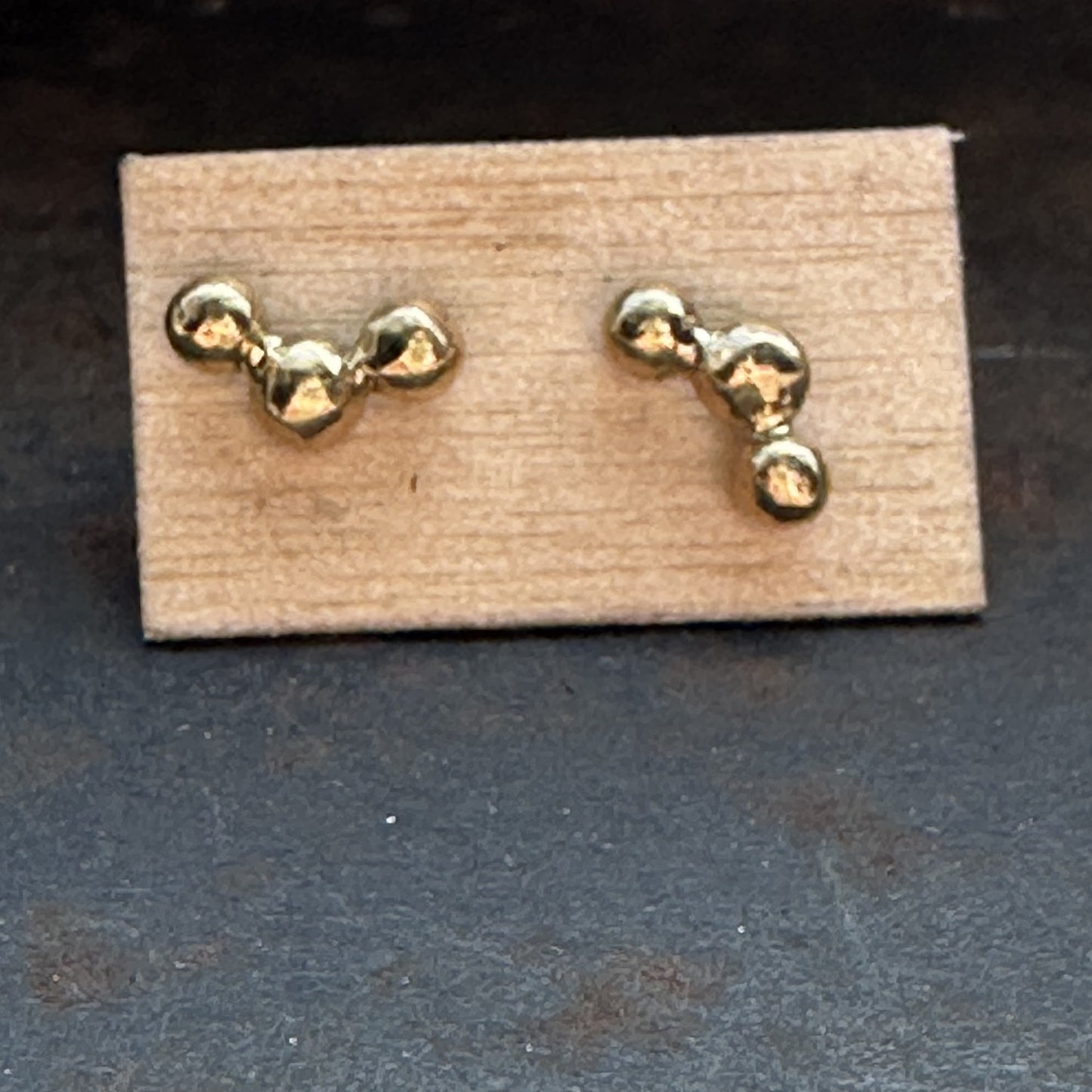 Close up of Hoshi Stud Earrings on Wood Fiber Paper