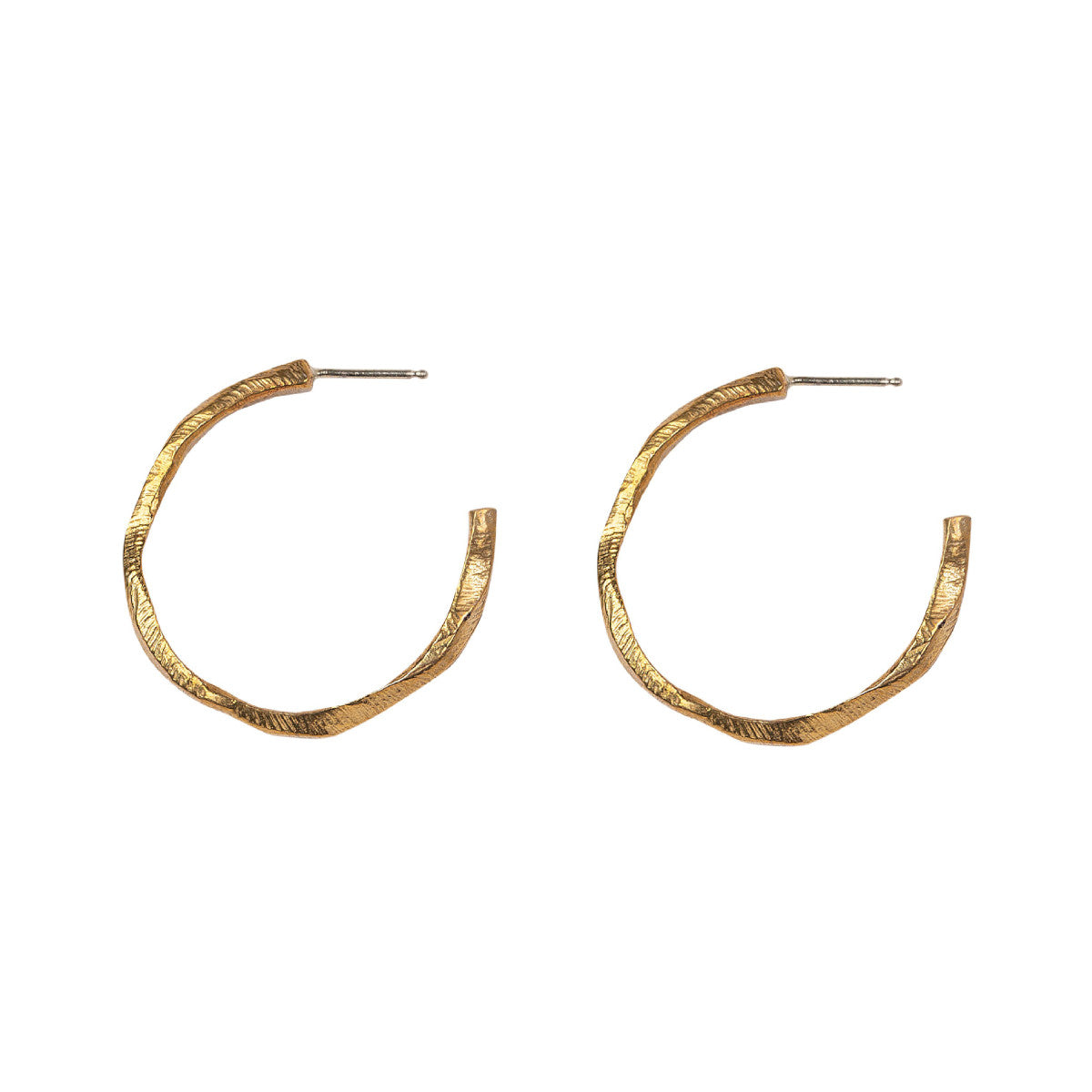 Our Small Hoop Earrings feature the same richly textured surface as their larger counterparts, evoking the weathered elegance of historic monoliths in a more subtle form. The Small Hoops are designed for versatility, perfect for everyday wear or as part of a curated ear stack.