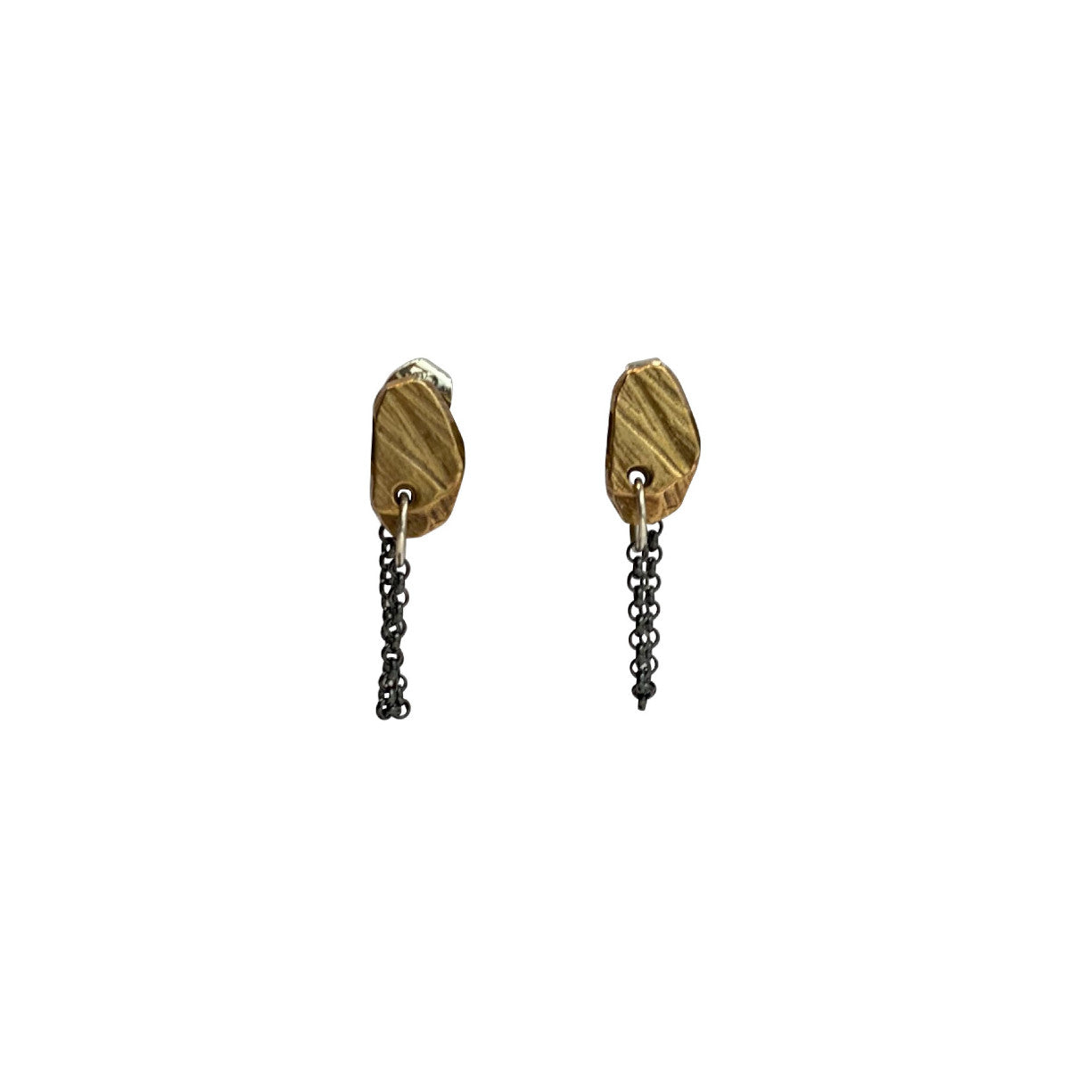 The Stone Stud with Chain Earrings feature a classic stud design, elevated by a delicate chain that drapes gracefully from the lobe. The attached chain adds movement and intrigue, creating a dynamic look that's both sophisticated and playful. Their versatile design allows for various wearing styles - traditionally in the lobe, or creatively styled up the ear for a more dramatic effect.