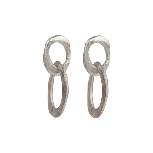 The Skipping Stones Double Oval Earrings feature two interconnected oval shapes, crafted with precision to create a fluid, harmonious design. Each pair shimmers in either Sterling Silver or Bronze with an otherworldly charm that catches both light and attention. The double oval structure allows for graceful movement, adding a dynamic element to your look.
