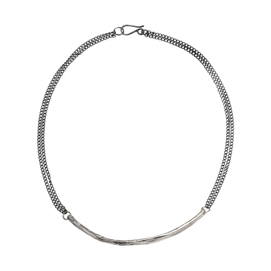 A silver necklace with a bar component and oxidized silver chain, featuring a hand made S hook clasp.