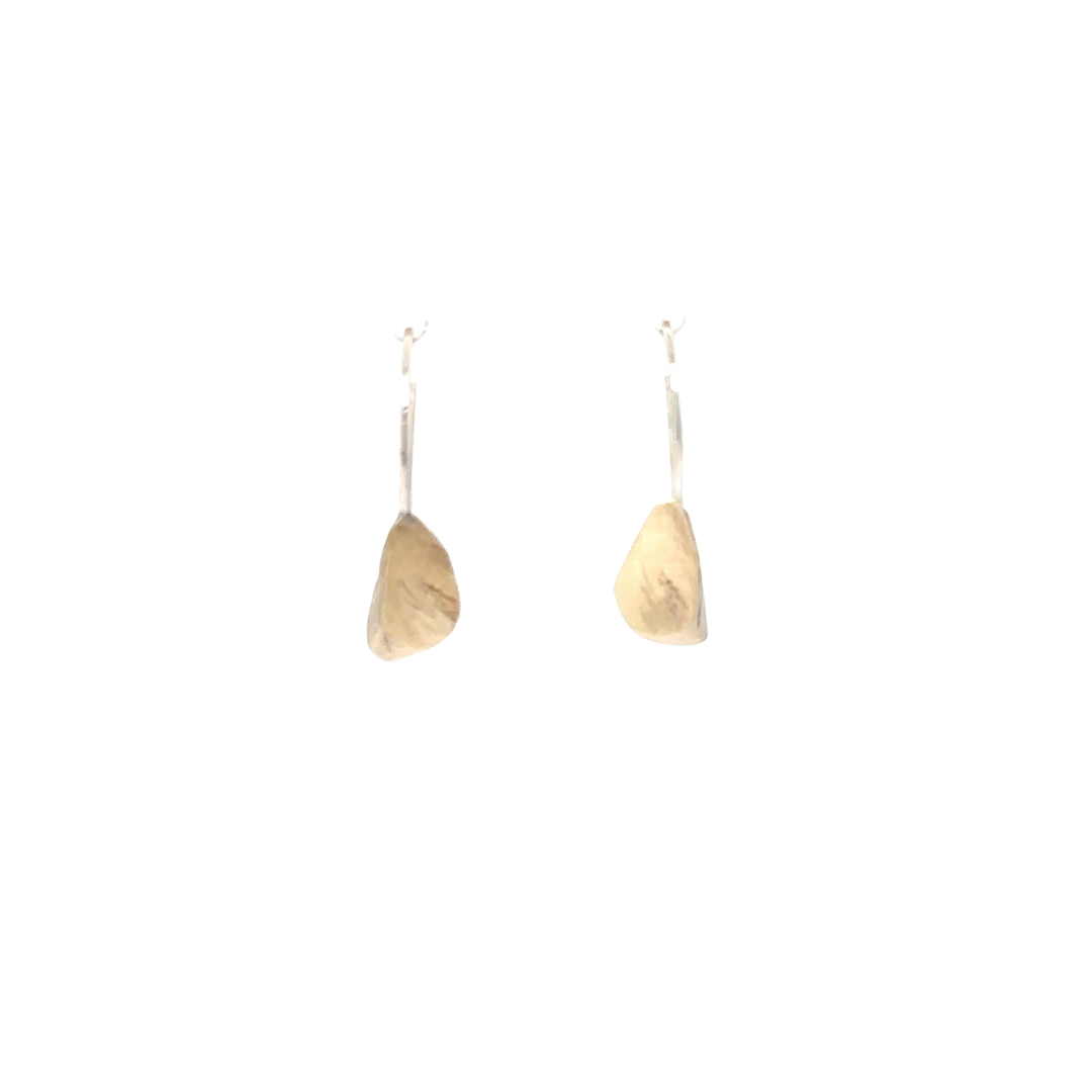 The Echo Earrings are a sculpture distilled in simplicity. A hand-formed piece rests from an ear wire, organic lines recalling the quiet strength found in nature. Lightweight yet impactful, they glow with a subtle radiance that reminds you light doesn't always need to be loud to be seen.
