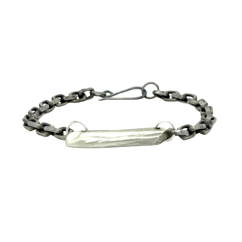 The Pulse Chain Bracelet anchors strength and grace at your wrist. A bold oxidized chain is centered with a hand-sculpted form that is raw, organic, and full of quiet power.