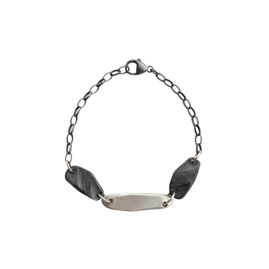 Delicate yet durable, this bracelet features intricately woven strands that symbolize the interconnectedness of life's experiences. The adjustable clasp ensures a perfect fit for any wrist size This exquisite piece has the sophistication of sterling silver and oxidized sterling silver in a harmonious design.