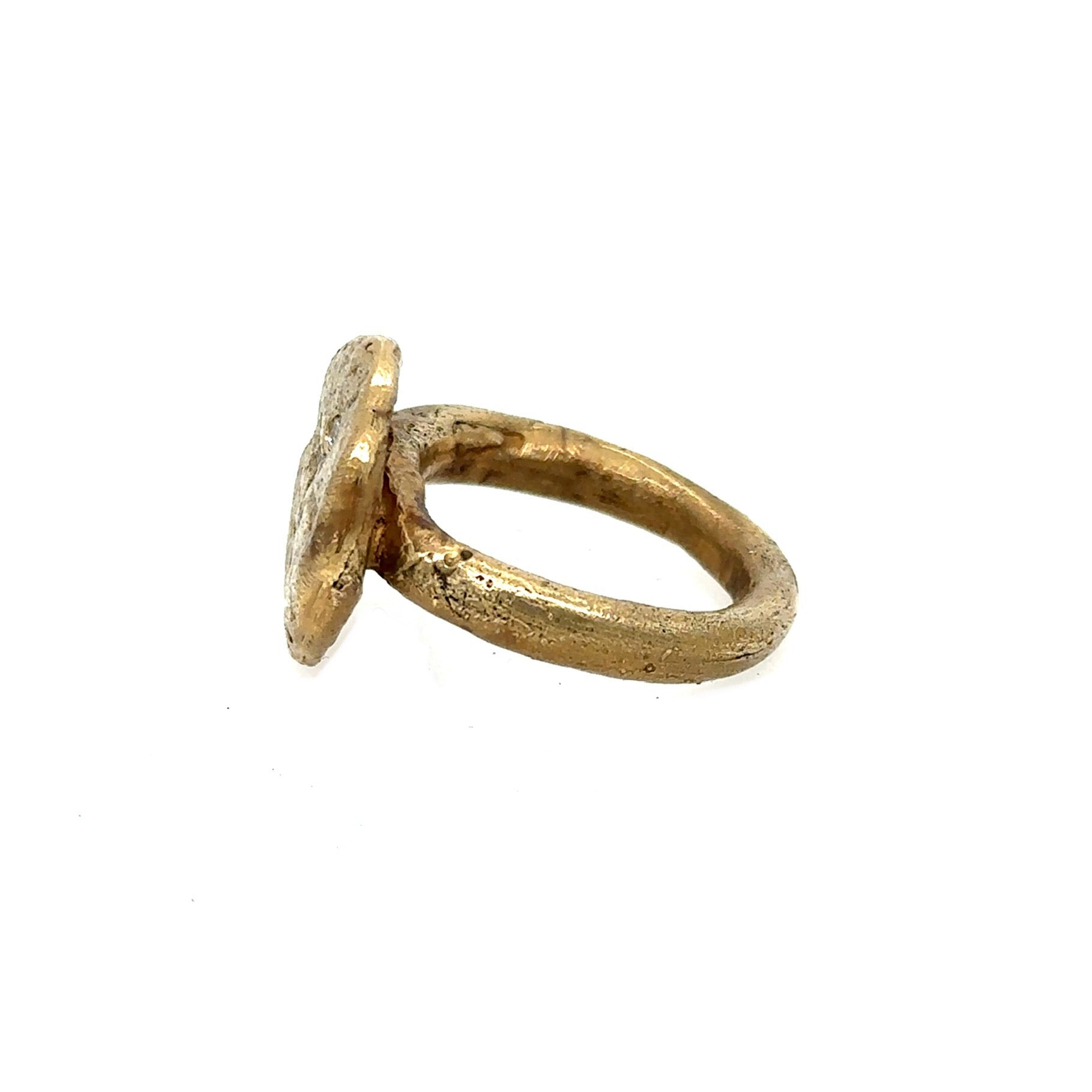 The surface of celestial bodies tells the story of their transformation – impacts and eruptions that forever changed their landscape. This textured disc ring captures that same raw beauty that mimics the terrain of distant worlds and the scattered diamonds appear like stars emerging from cosmic dust.