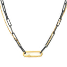 A blend of two worlds in one exquisite piece. This necklace features two chains: one in sophisticated black oxidized sterling silver and the other in luxurious 14K gold-filled metal. The contrasting tones create a subtle yet striking visual interest, perfect for those who appreciate nuanced style.