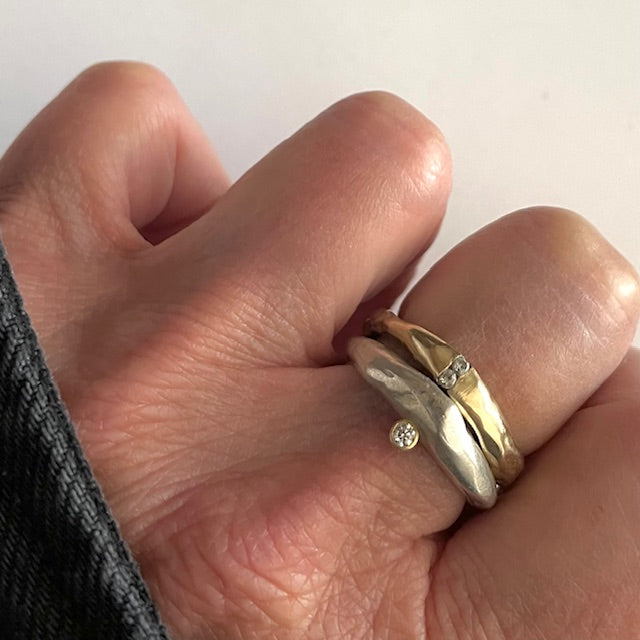 Channel Ring in Bronze and Odyssey ring in silver shown on persons hand 