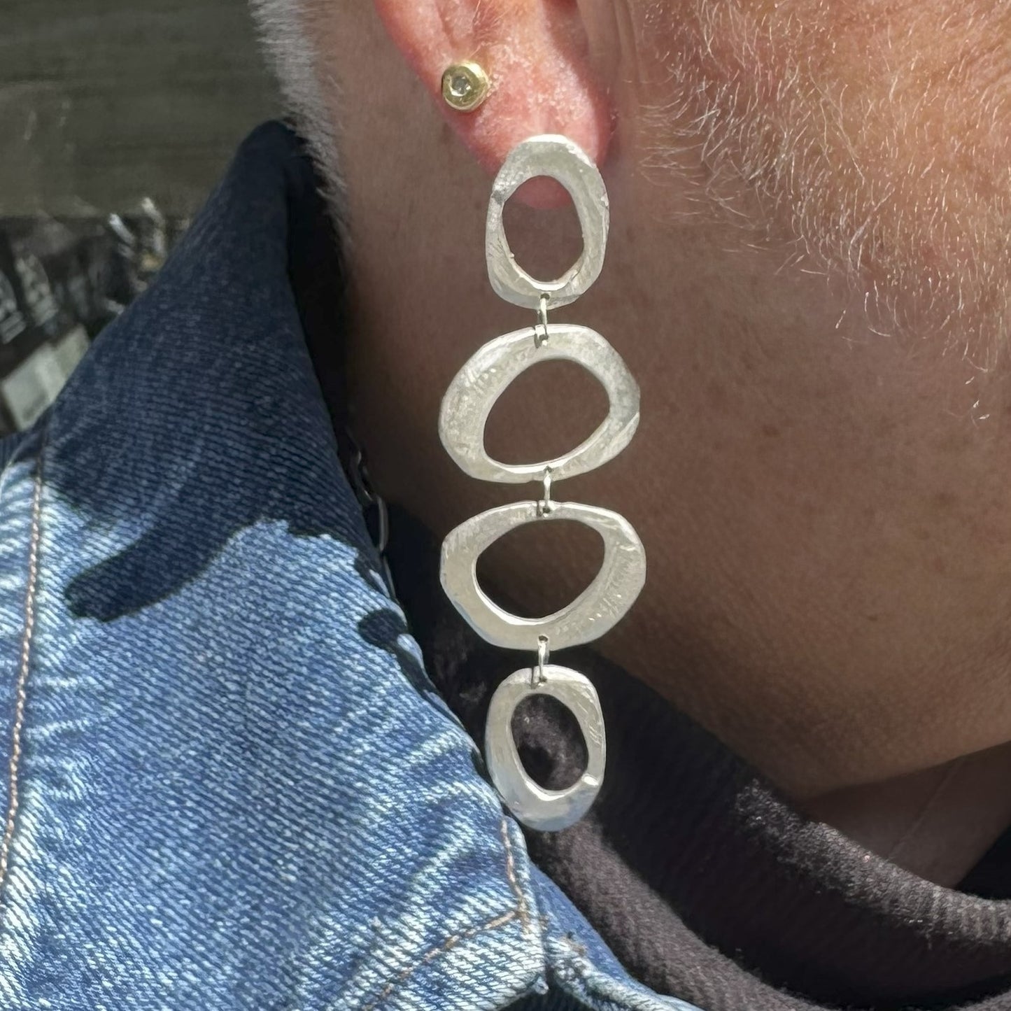 Close up of Mystic Statement Earrings in Silver on person