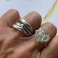 Cosmic Crater Ring in silver with Stack of Element and Constellation Rings in silver on persons hand